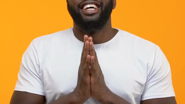 Grateful Black Man Praying on Yellow Background, Thanksgiving Ritual, Religion