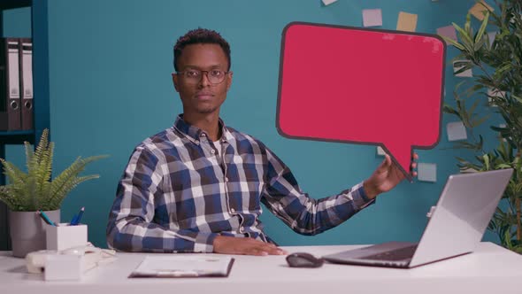 Male Employee Holding Speech Bubble on Card Board