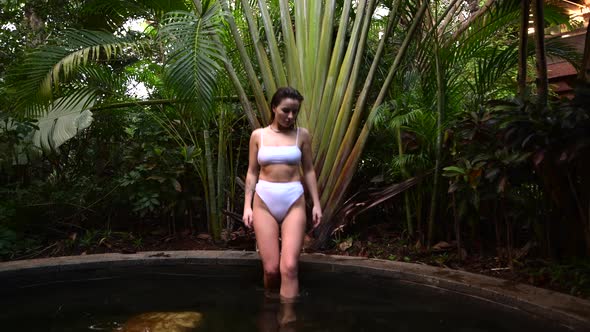 Handsome Young Caucasian Woman in Swimming Pool Tropical Park in Asia, Bali
