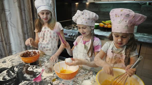 Girl cracking an egg over a bowl