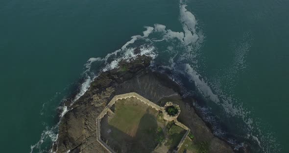 Flying over Historical Old Castle and Big Waves