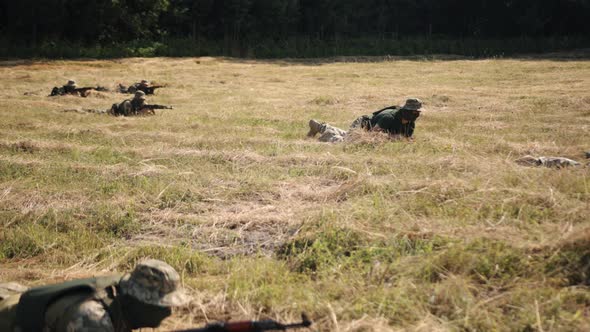 Military Special Forces Unit Soldiers with Weapons Ammunition are on Battlefield Attacking Enemy