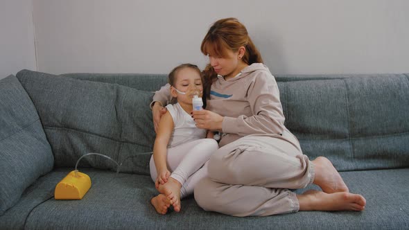 Mother Gives Her Baby Girl Inhalation with Medical Nebulizer Sick Bronchitis