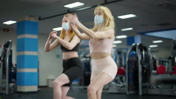 Live Camera Follows Blond and Redhead Slim Beautiful Caucasian Women in Covid19 Face Masks Training