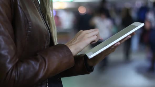 Woman Using A Modern Tablet In Underpass