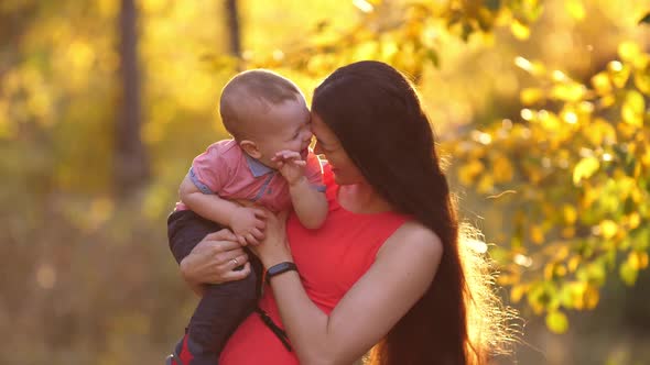 Cheerful Mother Play with Her Baby on Nature