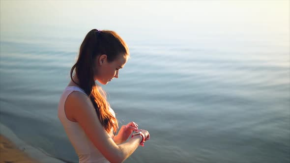 Young Woman Making Gestures on a Wearable Smart Watch Computer Device