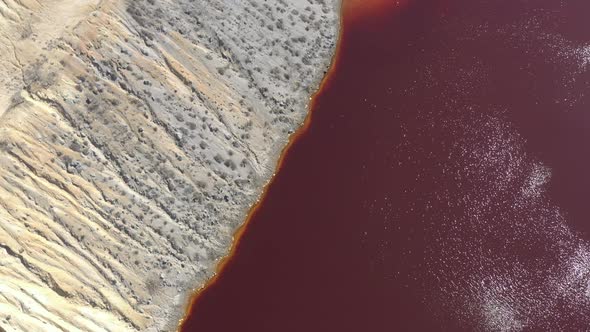 Red water containing metals from mine wastes 4K aerial video