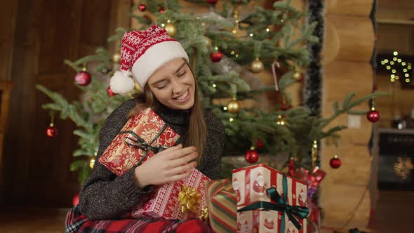 Woman putting down Christmas gifts