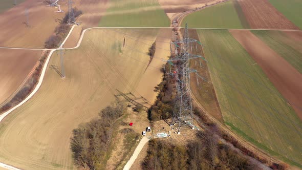 A Transmission Tower Carrying Electrical Lines In The Countryside. Aerial Drone Shot