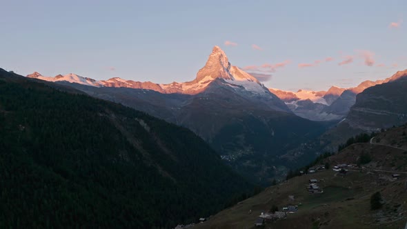 Descending drone shot over Blue Lake Oeschinen Kandersteg Switzerland mountains