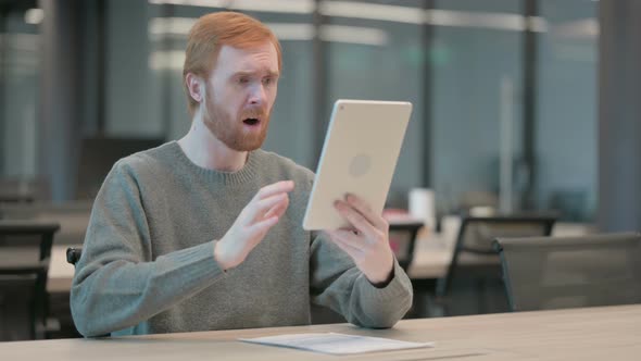 Young Man Reacting to Loss on Tablet in Office