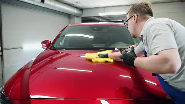 Man Polishing Cleaning Car with Microfiber Cloth Detailing or Valeting Concept