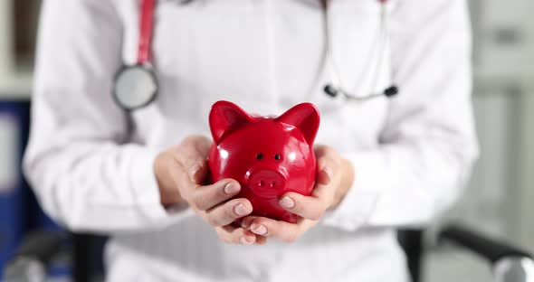 Woman Doctor is Holding Piggy Bank in Hands Slow Motion  Movie
