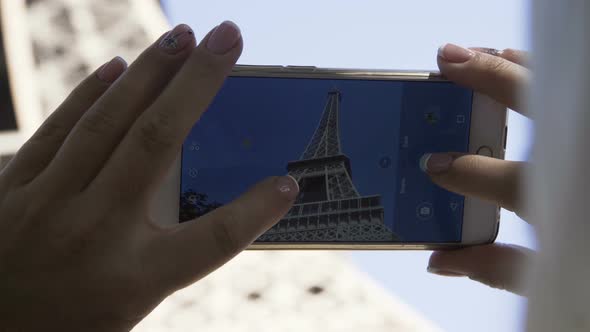 Crop Woman Taking Picture of Eiffel Tower