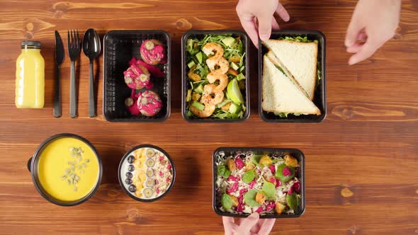 Food Delivery Top View Take Away Meals in Disposable Containers on Wooden Table