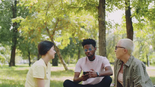 Multiethnic College Students and Teacher Talking in Park