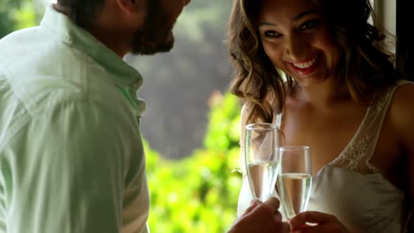 Romantic couple toasting champagne glasses