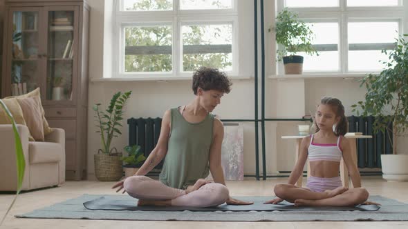 Mother and Daughter Stretching Together