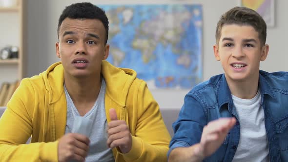 Two Teenage Friends Watching Sports on Tv, Favorite Team Losing, Upset Fan Boys