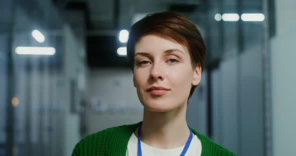 A Businesswoman Smiling Looking Into Camera in the Office