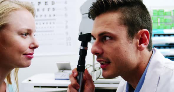 Close-up of optometrist looking through ophthalmoscope