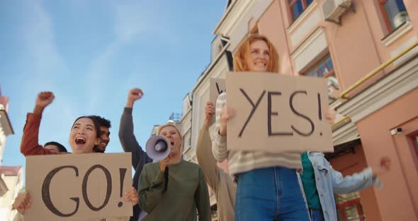 Happy Protesters with Go and Yes Placards Celebrate Victory