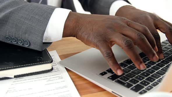 Businessman using laptop at his desk