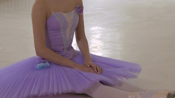 Ballerina stretching on the floor