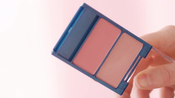 Female Hands Holding Make Up Palette with Blush Close Up