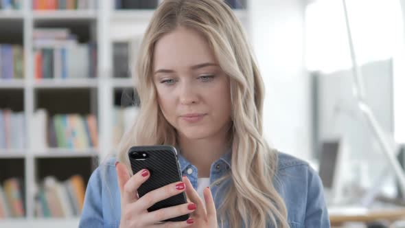 Young Woman Using Phone Typing Message