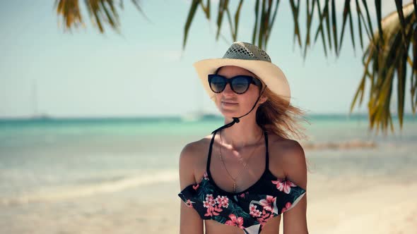 Girl In Bikini Walking On Tropical Hawaii Beach.Woman In Swimsuit And Hat Walks Caribbean Coast