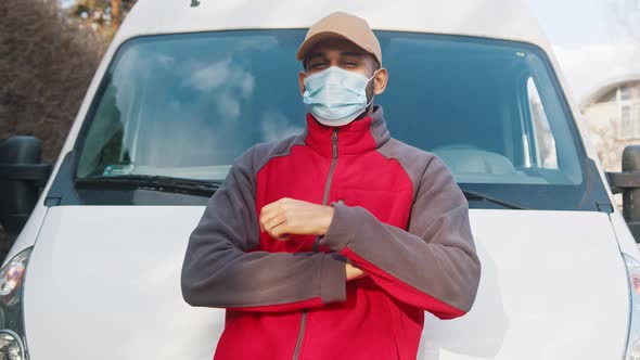 Delivery Man with Face Mask Showing Thumbs Up in Front of the Van