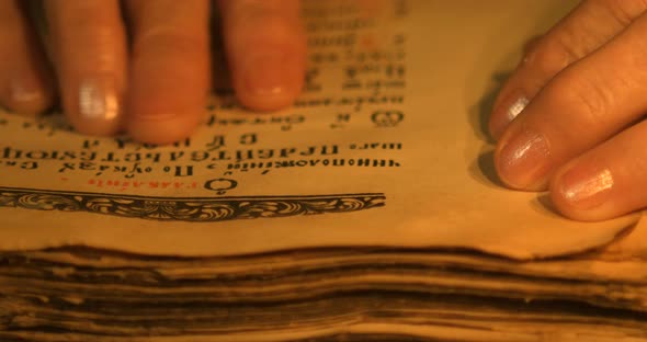 Elderly woman reading old book