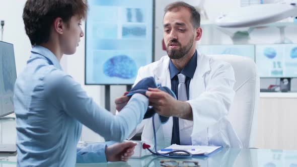 Researcher Measuring Blood Pressure To a Young Female Candidate