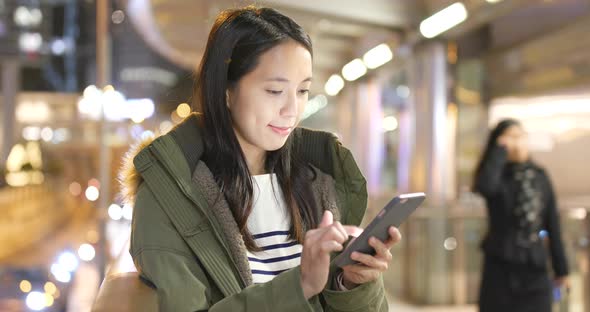 Woman use of smart phone at night