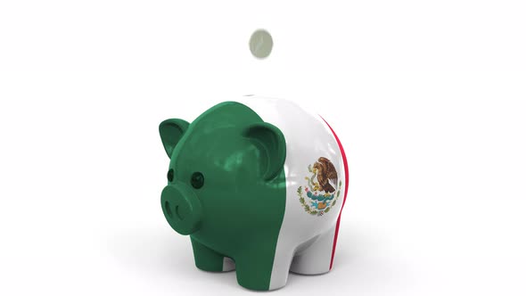 Coins Fall Into Piggy Bank Painted with Flag of Mexico alt