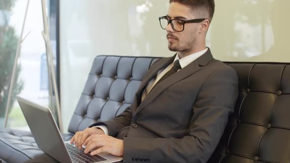 Businessman in Glasses Working on Project in Office