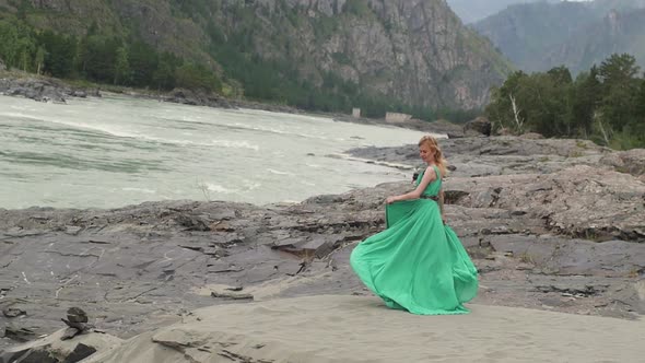 Young Woman in a Long Flowing Dress on the Background of the River and Mountains. Coloring Women
