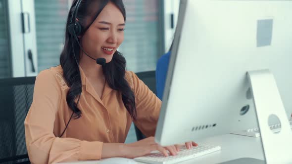 Businesswoman Wearing Headset Working Actively in Office