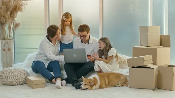 Parents With Children Use a Credit Card for Online Shopping. Buying By the Internet.