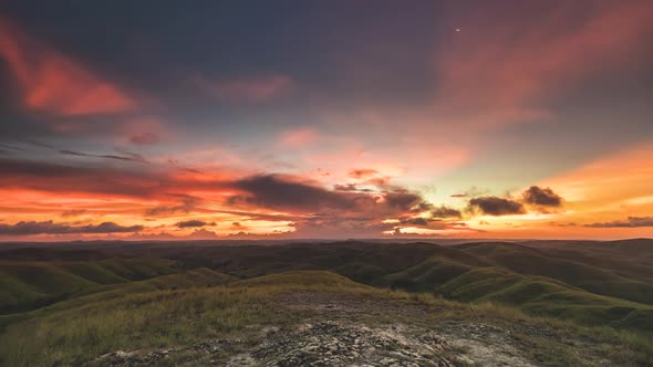 Picturesque Wairinding Hills Against Sunset in Orange Sky