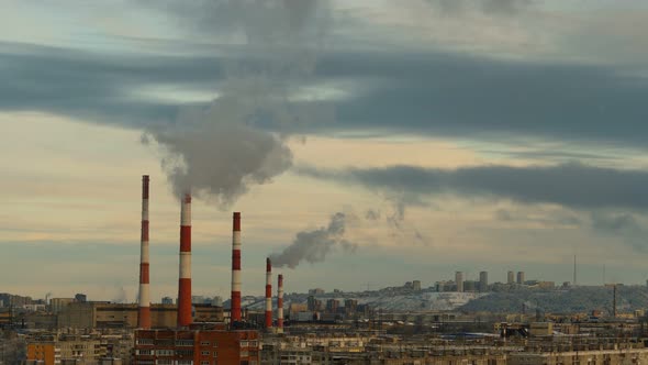 Smoke From Pipes in the Air. Large Pipes of Industrial Factory Produce Chemical Smoke in the Evening