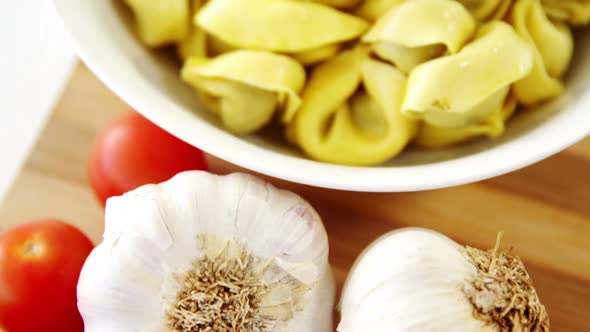 Garlic with bowl of pasta