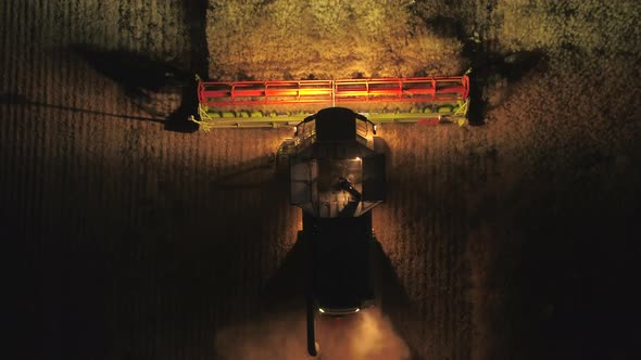 Night Time Harvest Using a Large Combine Harvester in a Field