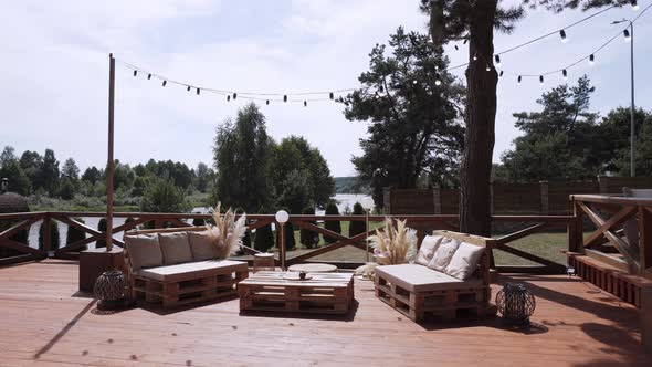 Ecofriendly Lounge Area with Soft Seats on Wooden Pallets on Terrace