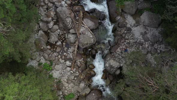 Top Aerial View Of Mountain River And Tourist On Rock