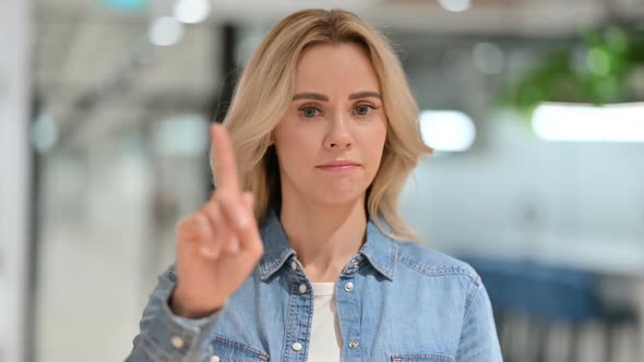 Disapproving Young Woman with No Sign By Finger