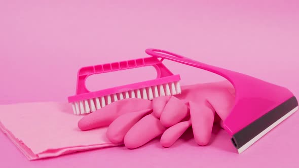 A Dust Rag Rubber Latex Gloves a Pink Plastic Brush and a Window Cleaner