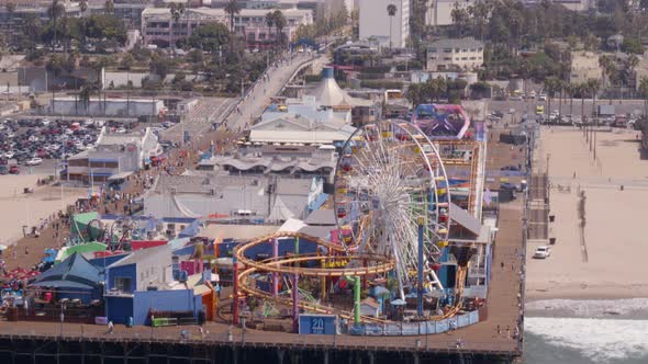 Aerial of Ferris wheel and amusement park rides at Pacific Park